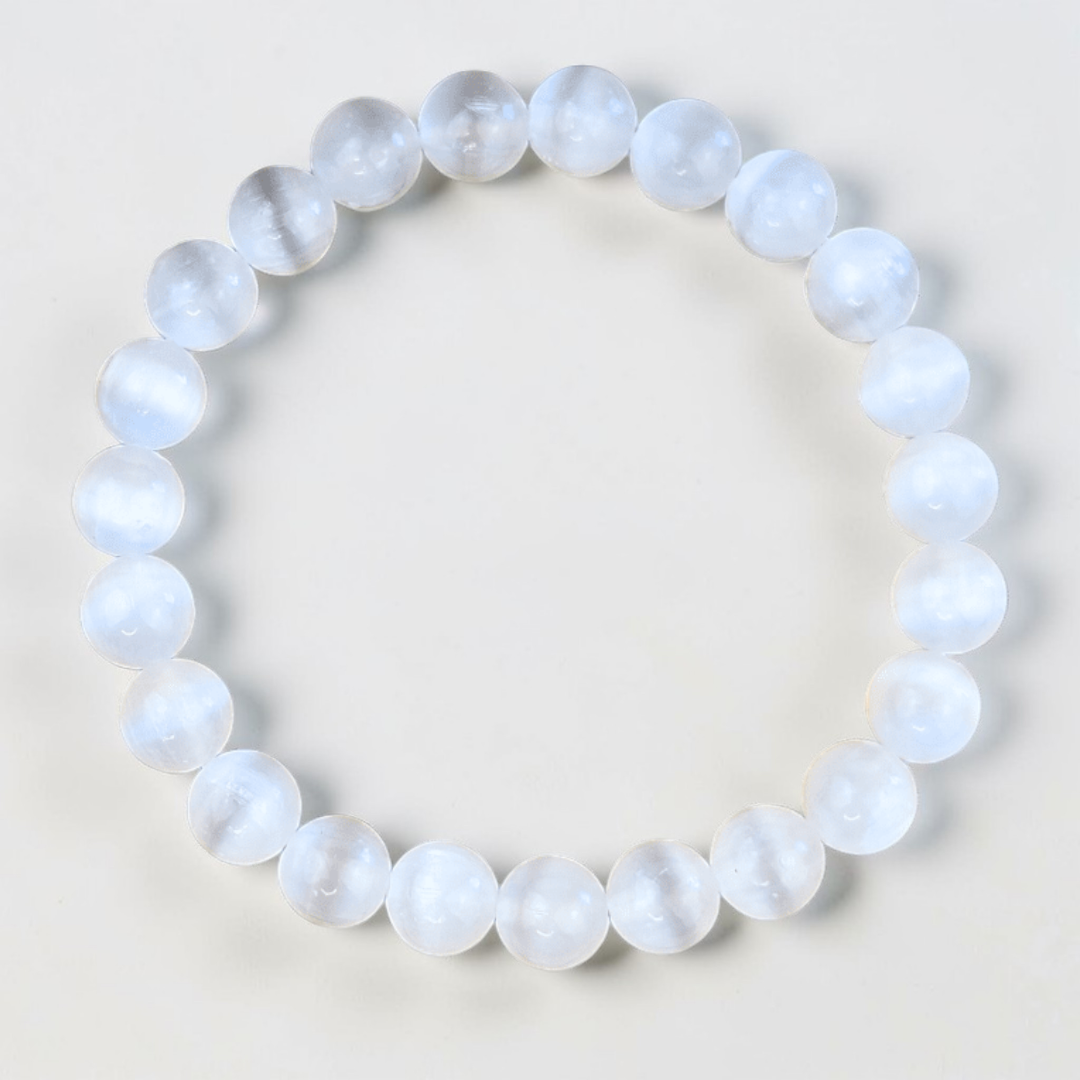 Close-up of 8mm Selenite beads on an adjustable bracelet