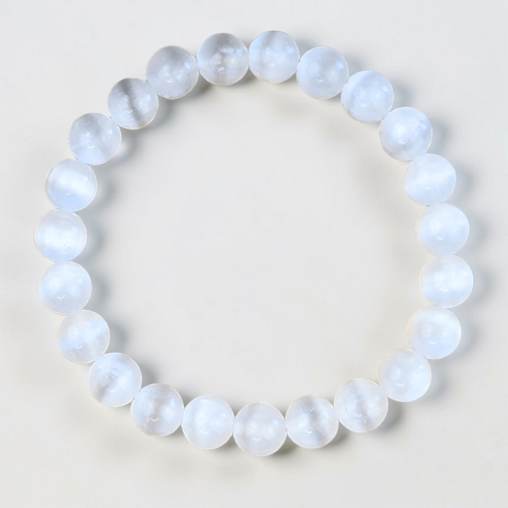 Close-up of 8mm Selenite beads on an adjustable bracelet