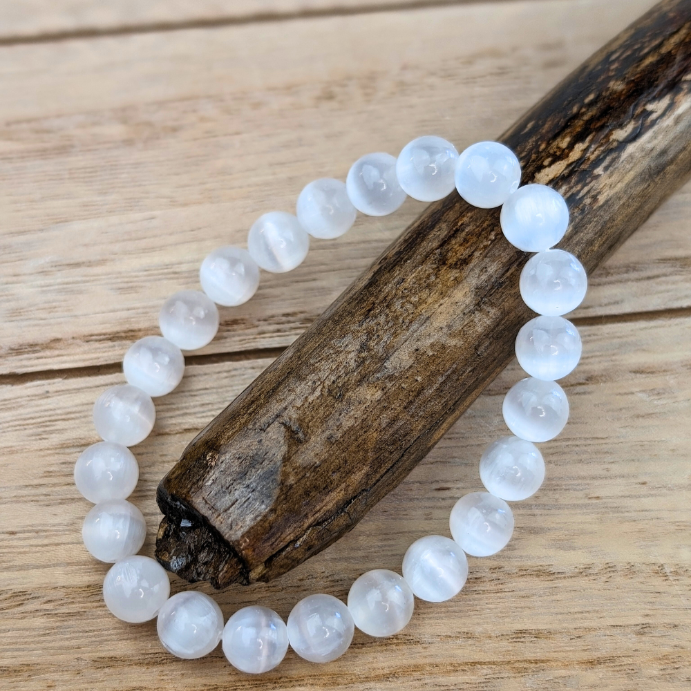 Close-up of 8mm Selenite beads on an adjustable bracelet