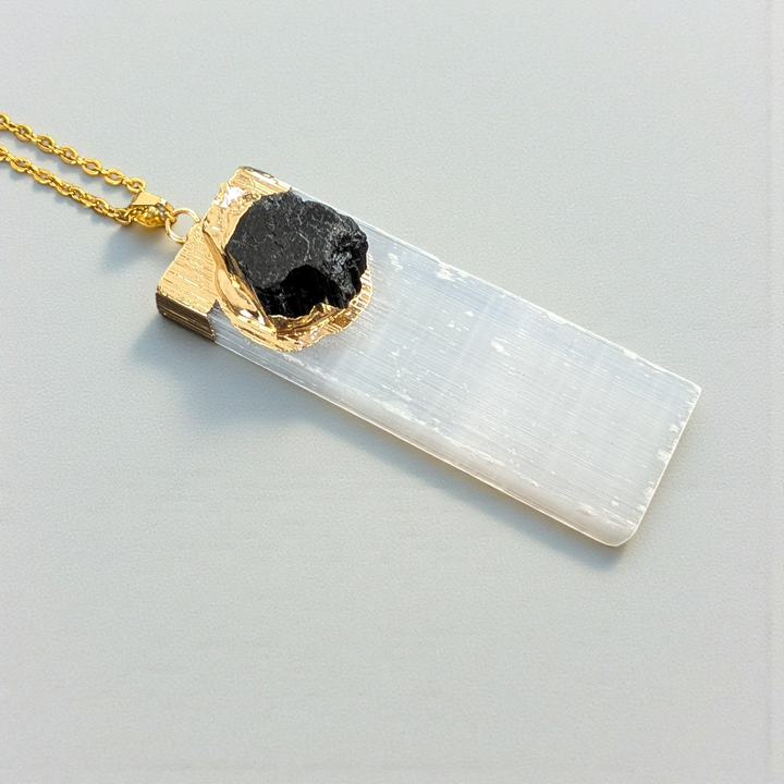 Raw black tourmaline and selenite pendant detail.