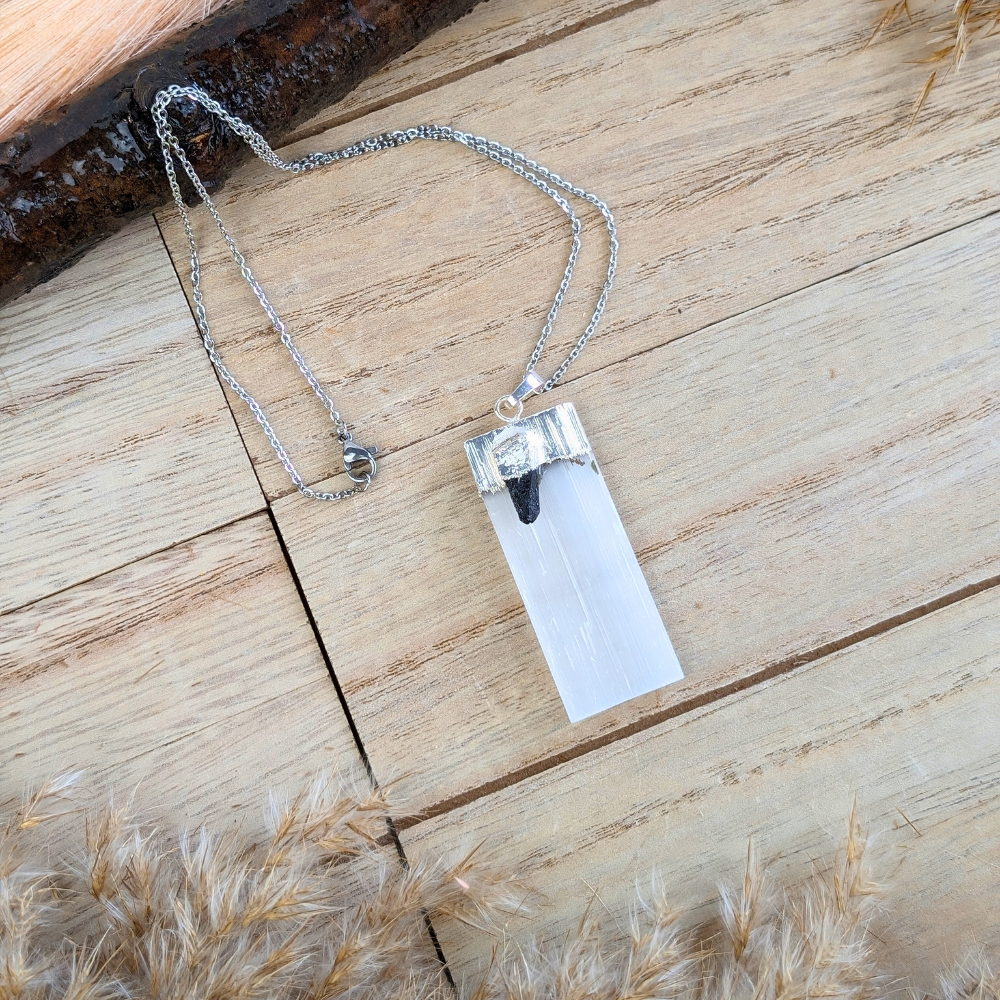 Raw black tourmaline and selenite pendant detail.