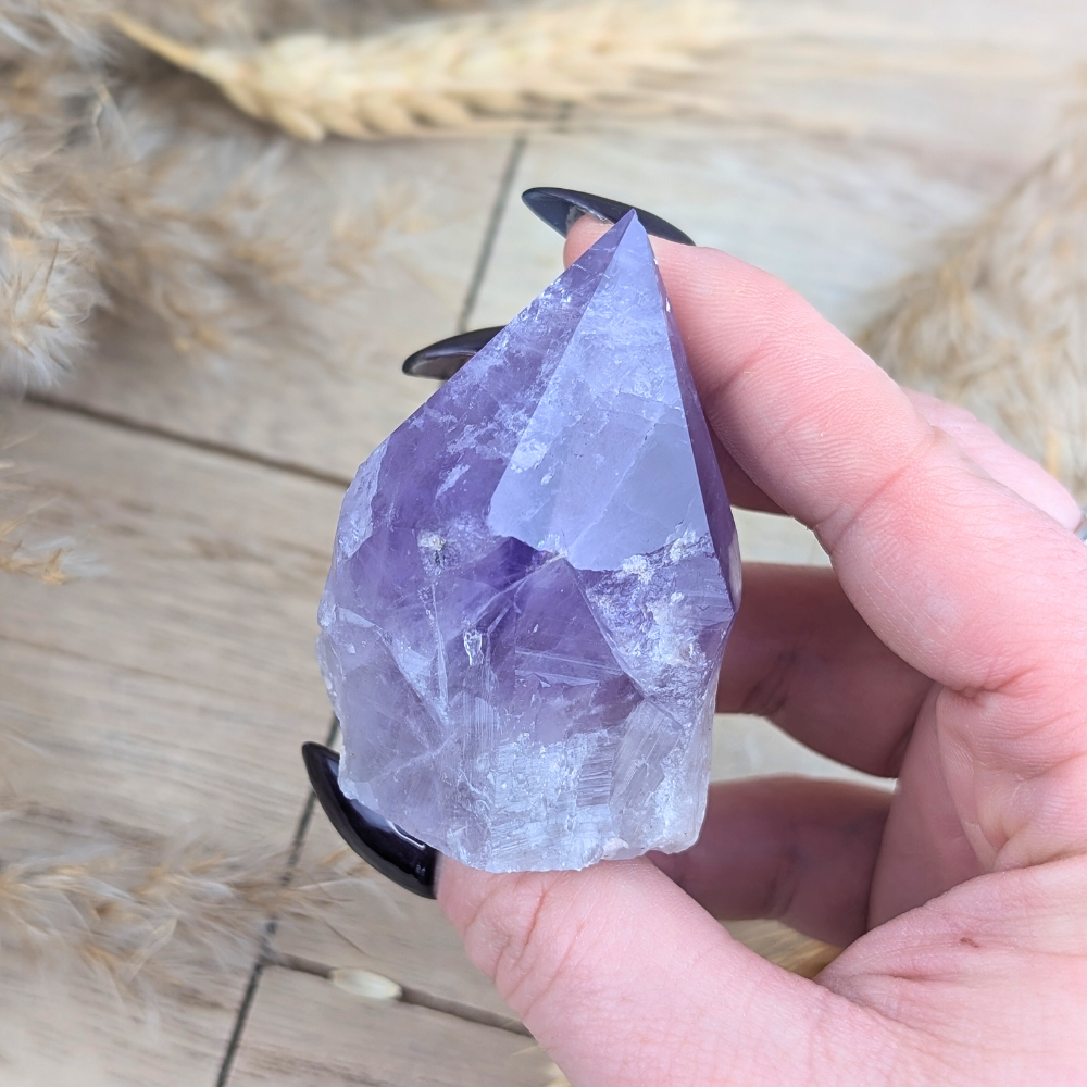 Close-up of Small Amethyst Point crystal in hand