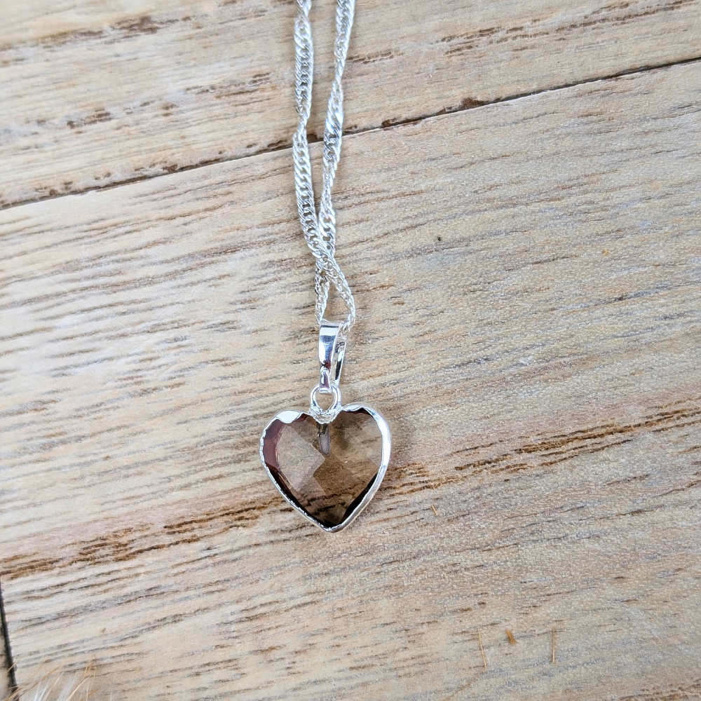 Minimalistic Smoky Quartz necklace on wooden background.