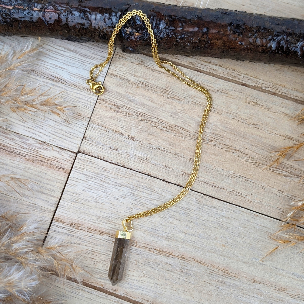 Smoky Quartz Point Necklace on a wooden background