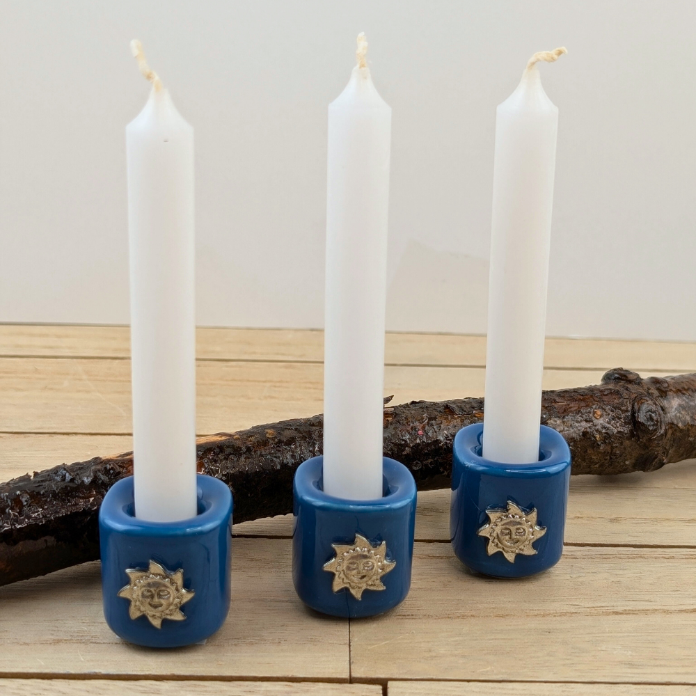 Ceramic candle holder with golden sun charm