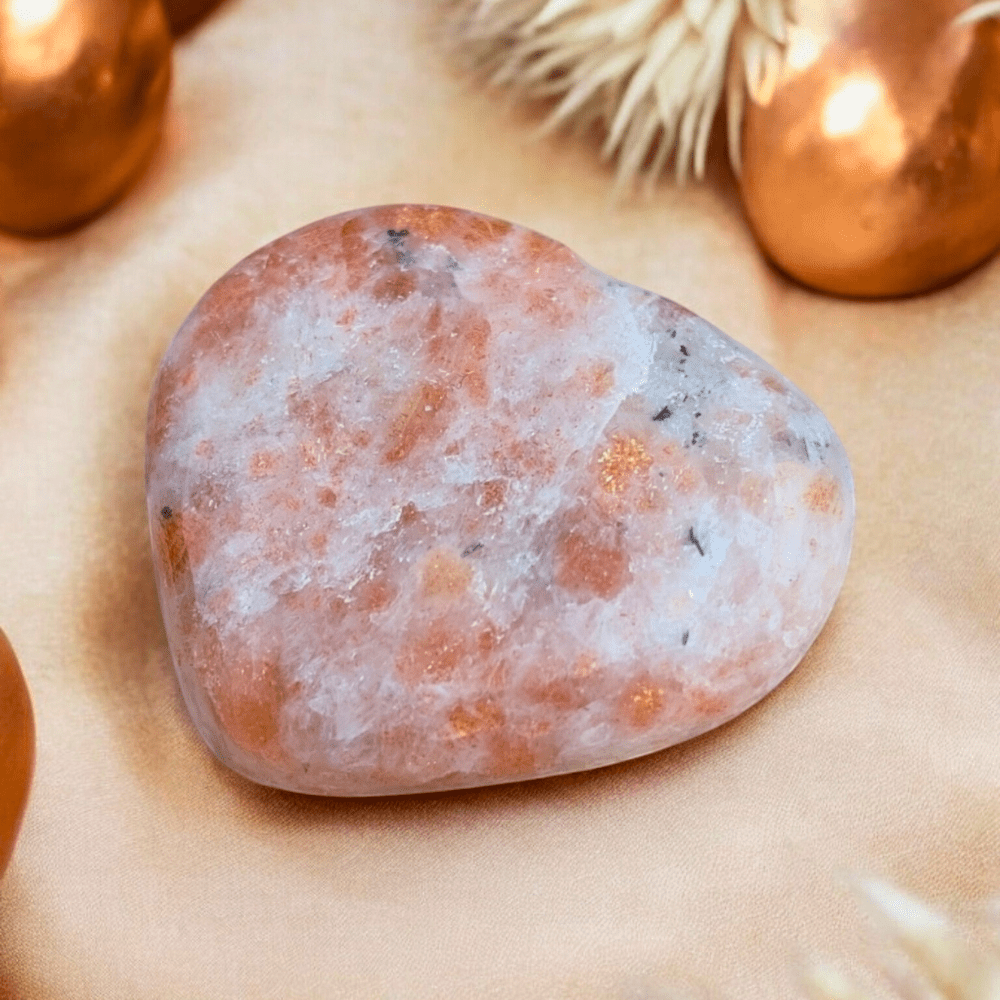 Close-up of Sunstone Crystal Heart in vibrant orange tones.