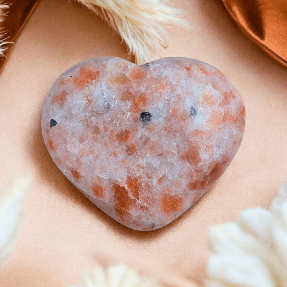 Sunstone Crystal Heart on soft fabric background.