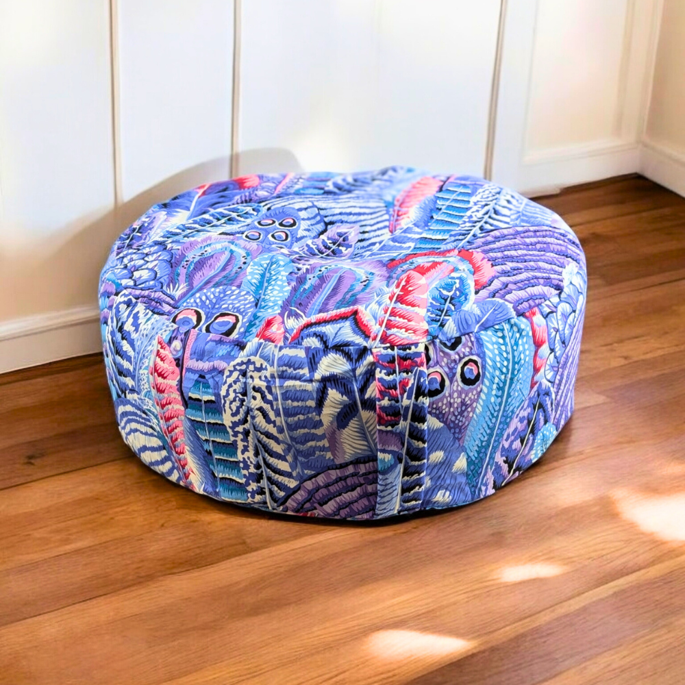 Vibrant Feather Meditation Pillow on a wooden floor