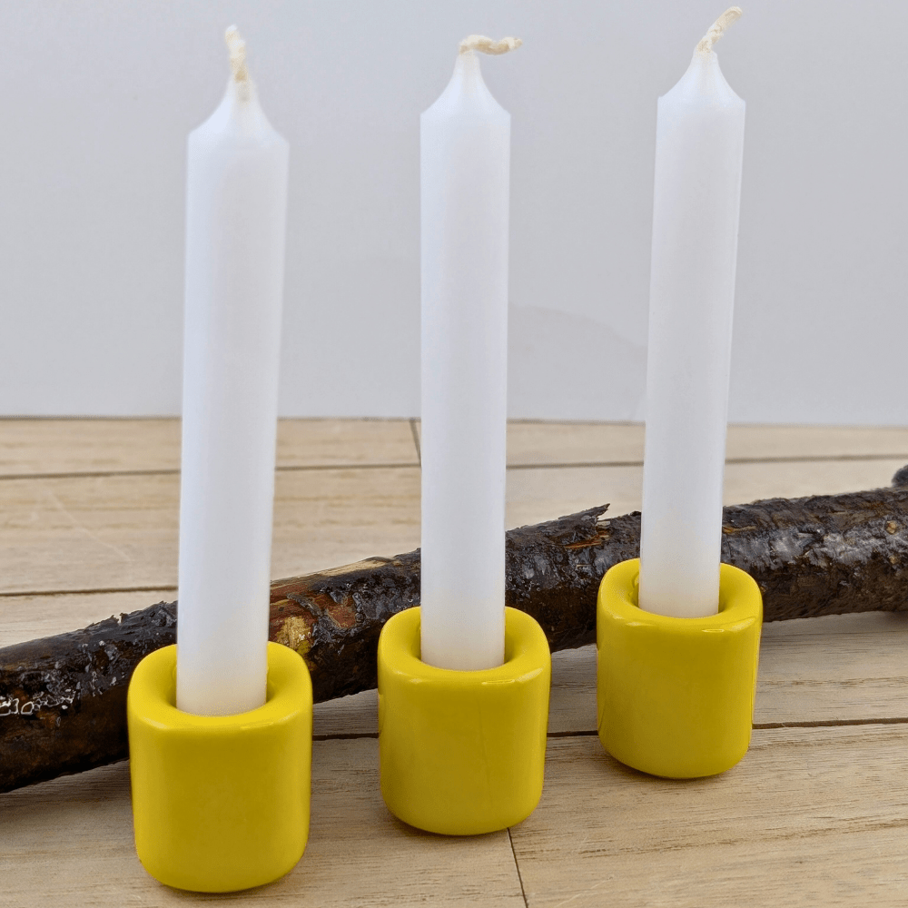 Ceramic candle holder with a bright yellow finish