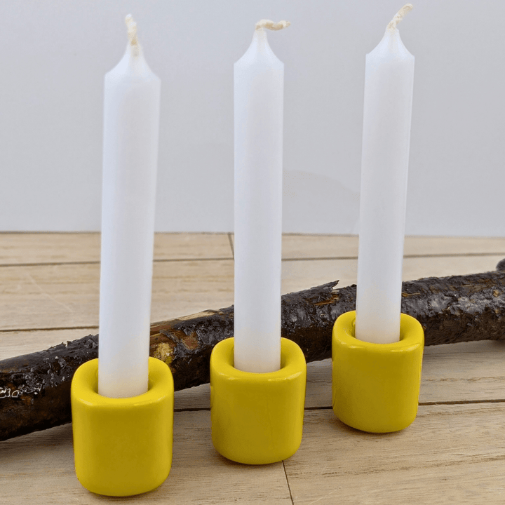 Ceramic candle holder with a bright yellow finish