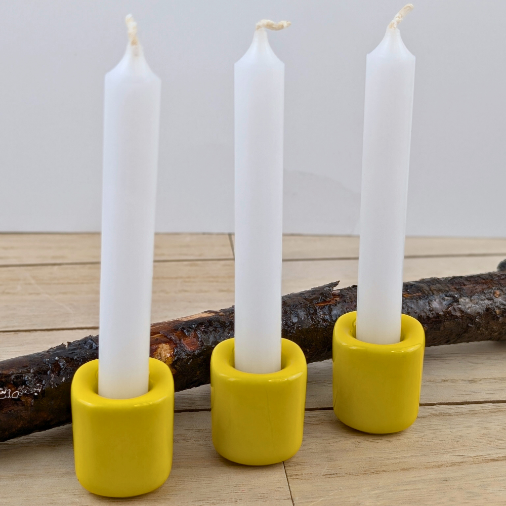 Ceramic candle holder with a bright yellow finish