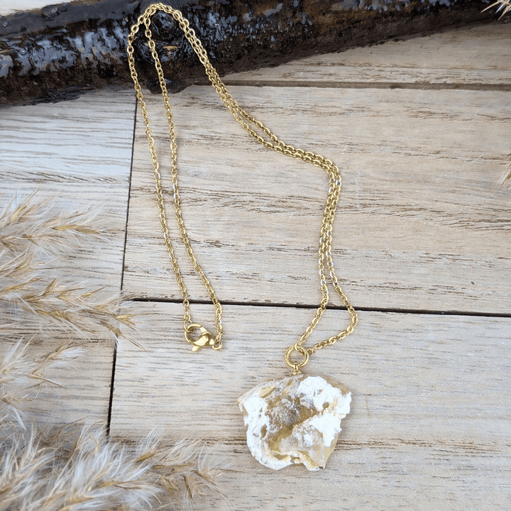 Close-up of the Yellow Opal pendant necklace displayed on a wooden surface