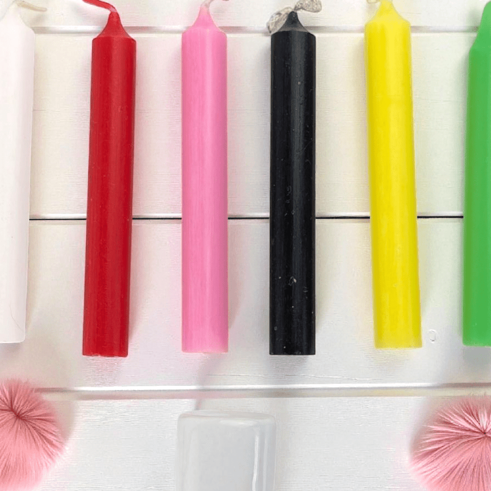 Set of colorful spell candles on a white background. Available at Zen Collection Crystal Store in Barrie