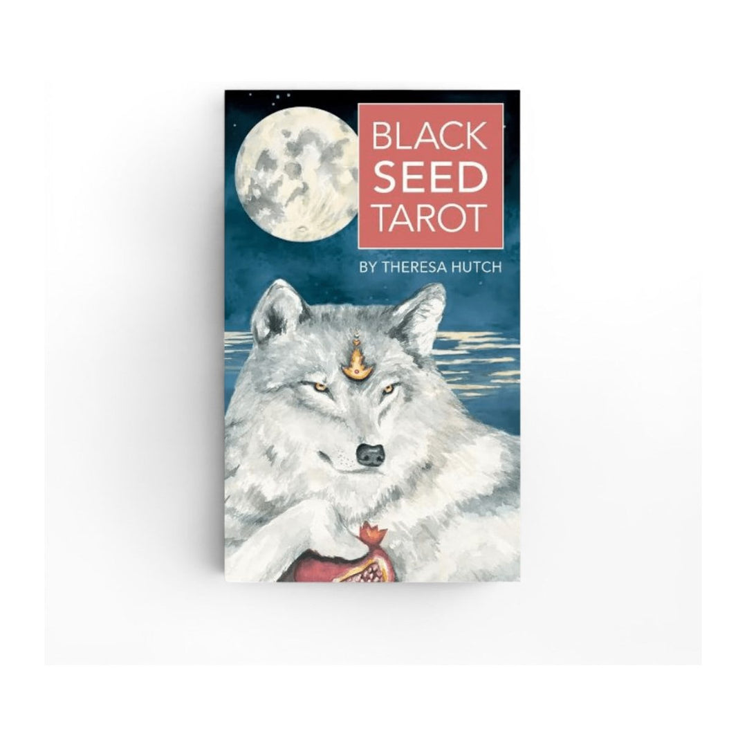 Black Seed Tarot box front by Theresa Hutch, showing a white wolf under a full moon