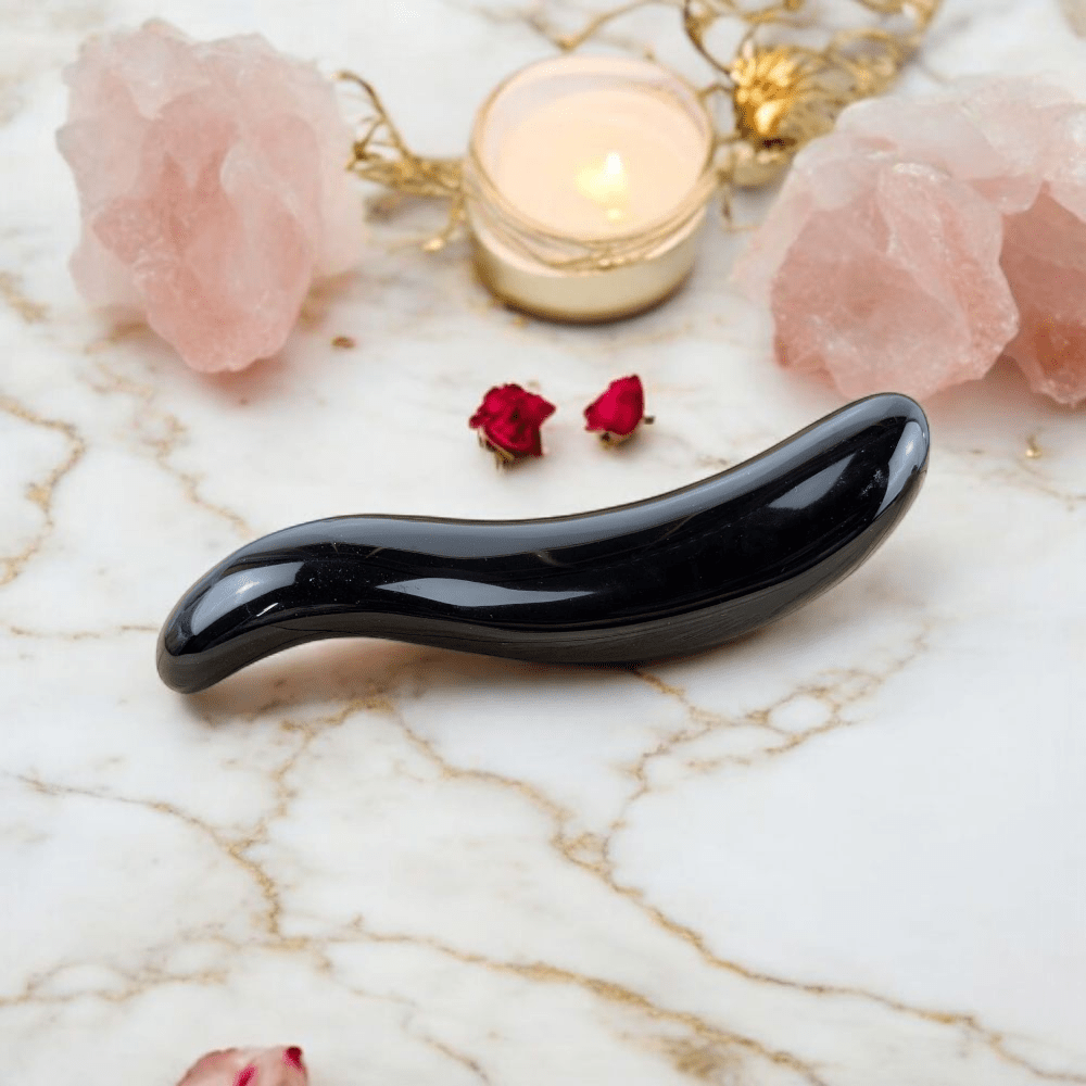 Woman’s Black Obsidian Massager on marble background