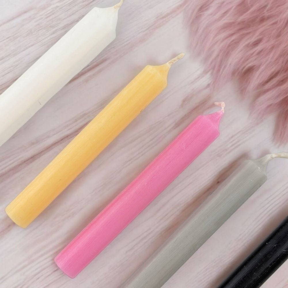breakup and moving on candle set with five chime candles on a wooden surface with a pink fluffy object.