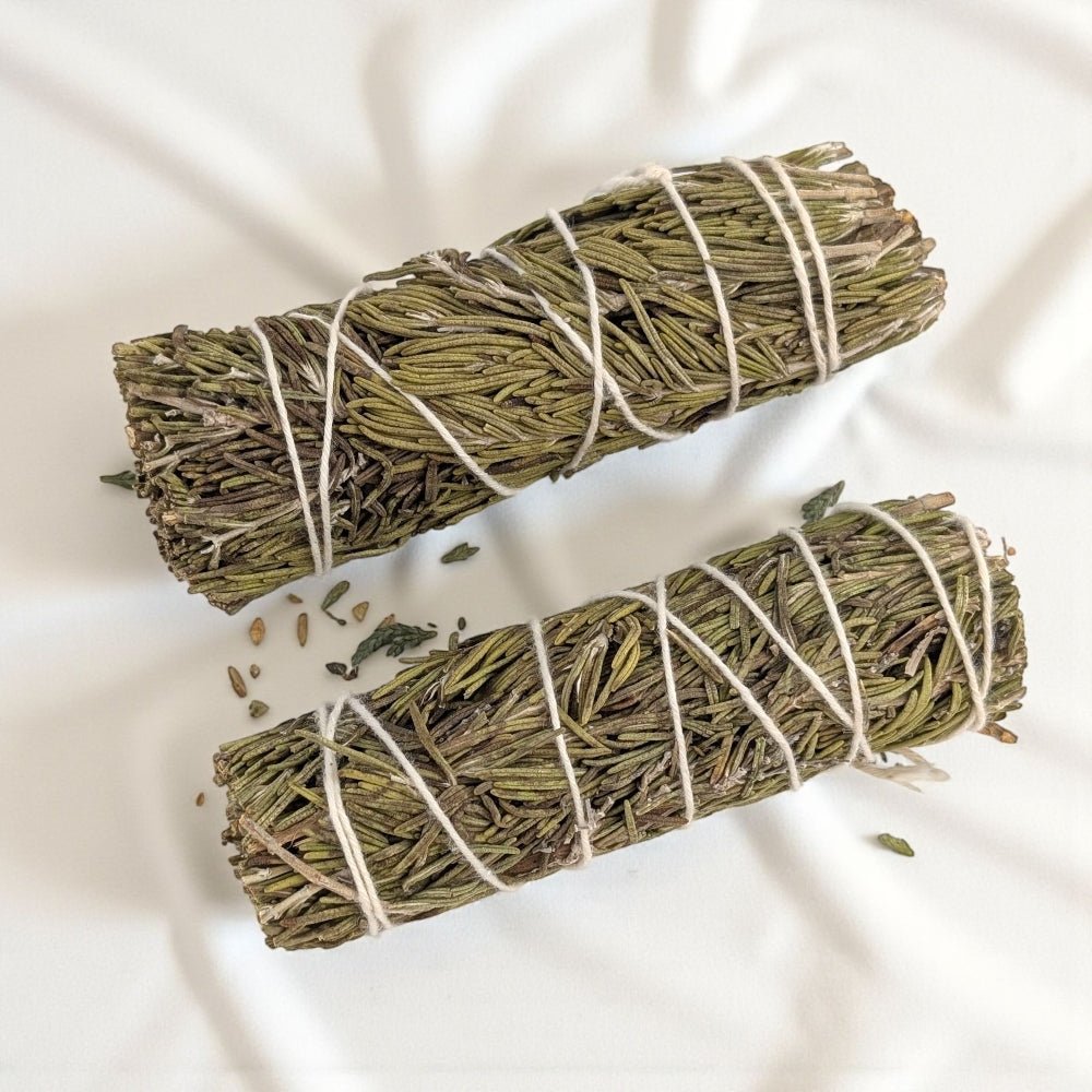 Two bundles of rosemary tied with twine on a light background from zen collection barrie metaphysical shop