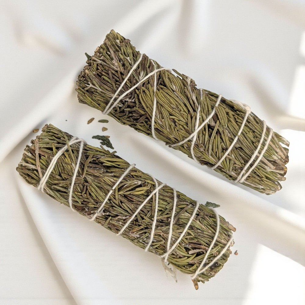 Two bundles of rosemary tied with twine on a white background from zen collection metaphysical store