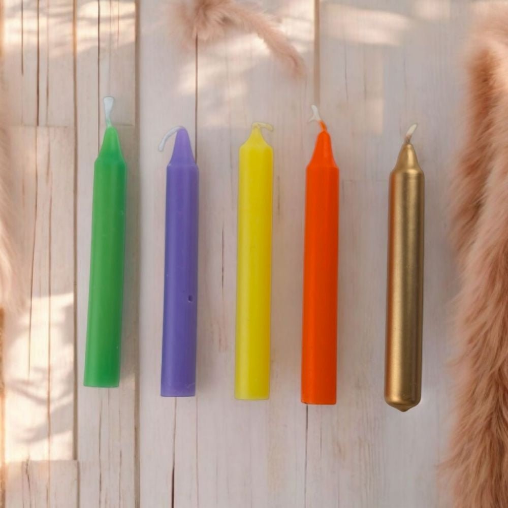 Set of colorful canadian metaphysical store inspiration candle set on a wooden surface with natural light