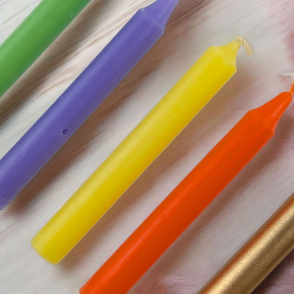 Colorful chime candles on a wooden surface