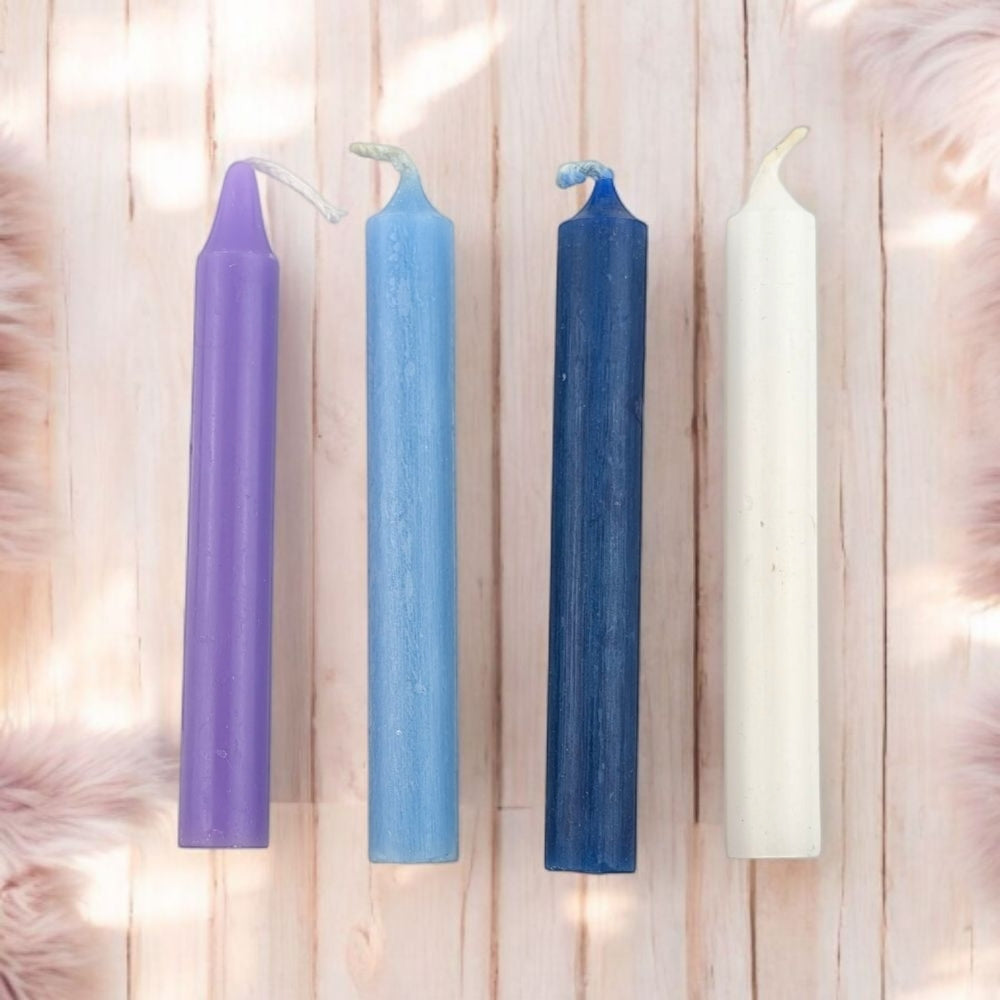 Spiritual wisdom Candle Set of 4 chime candle laid out flat on a wooden surface 