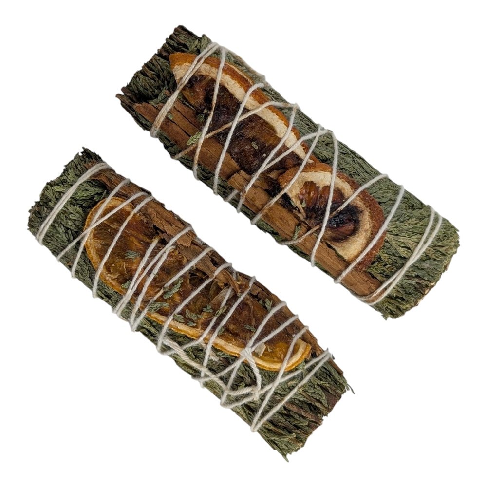 Two bundles of cedar and juniper smudge sticks tied with white string on a white background available at zen collection crystal stores in barrie
