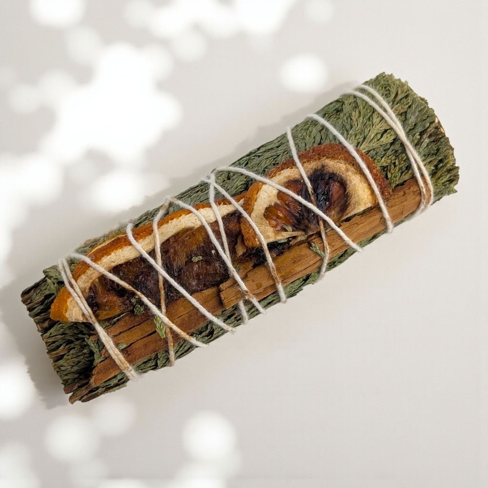 Rolled cedar and cinnamon bundle tied with twine on a light background sourced by zen collection crystal store in barrie