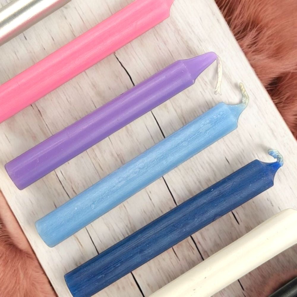 Empath Support Set of colorful chime candles on a white surface
