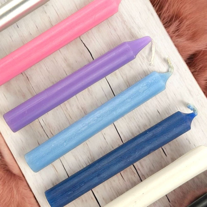 Empath Support Set of colorful chime candles on a white surface