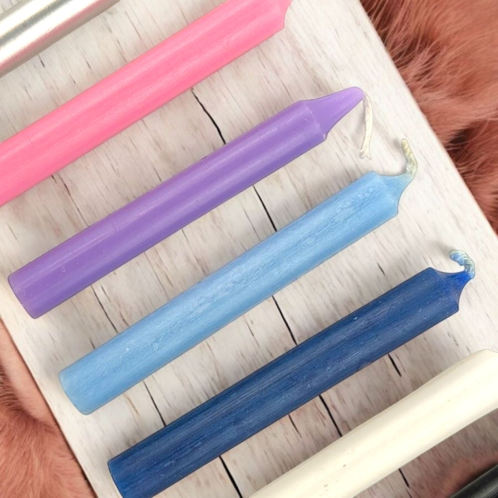 Empath Support Set of colorful chime candles on a white surface