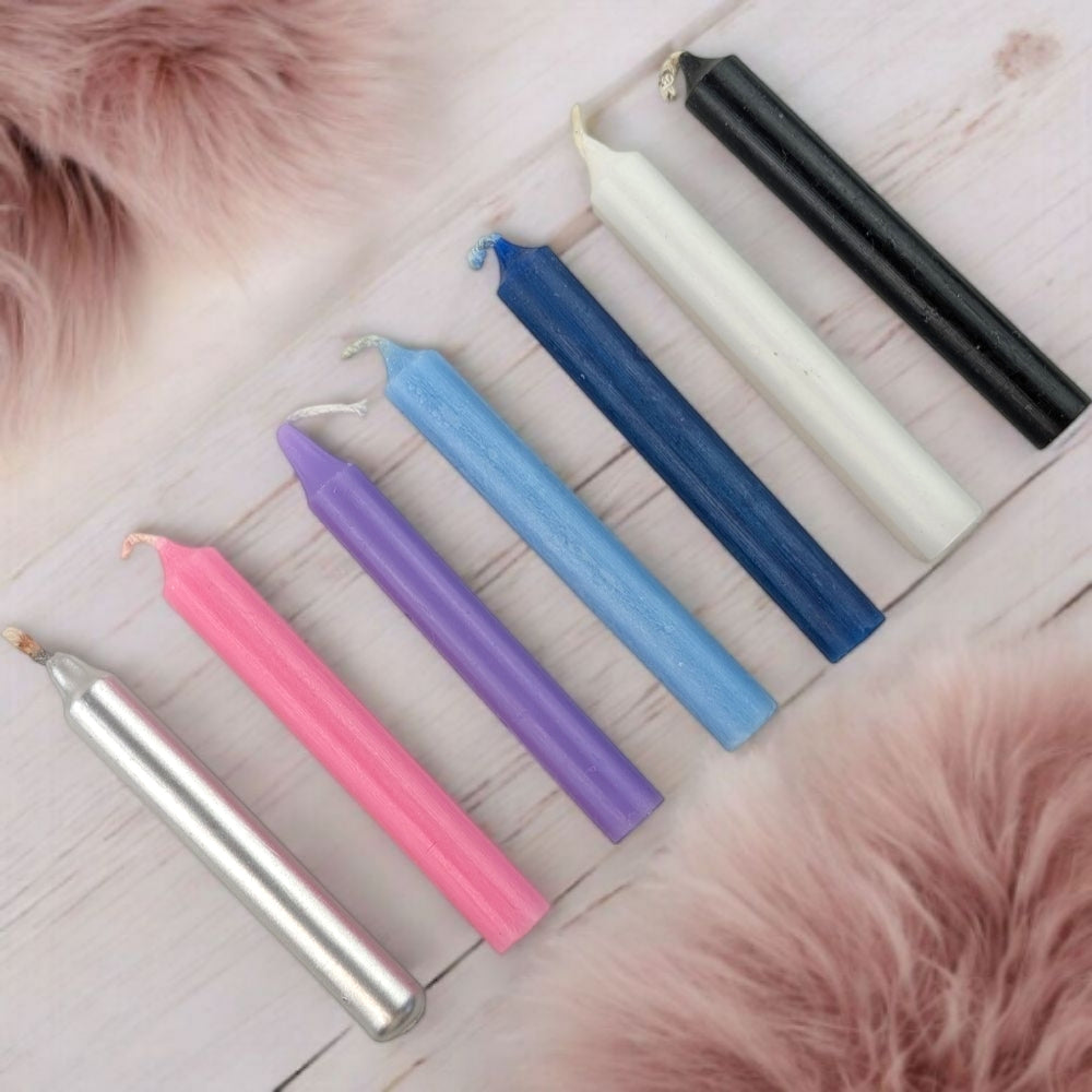 Empath Support Set of colorful candles on a wooden surface with pink fur accents