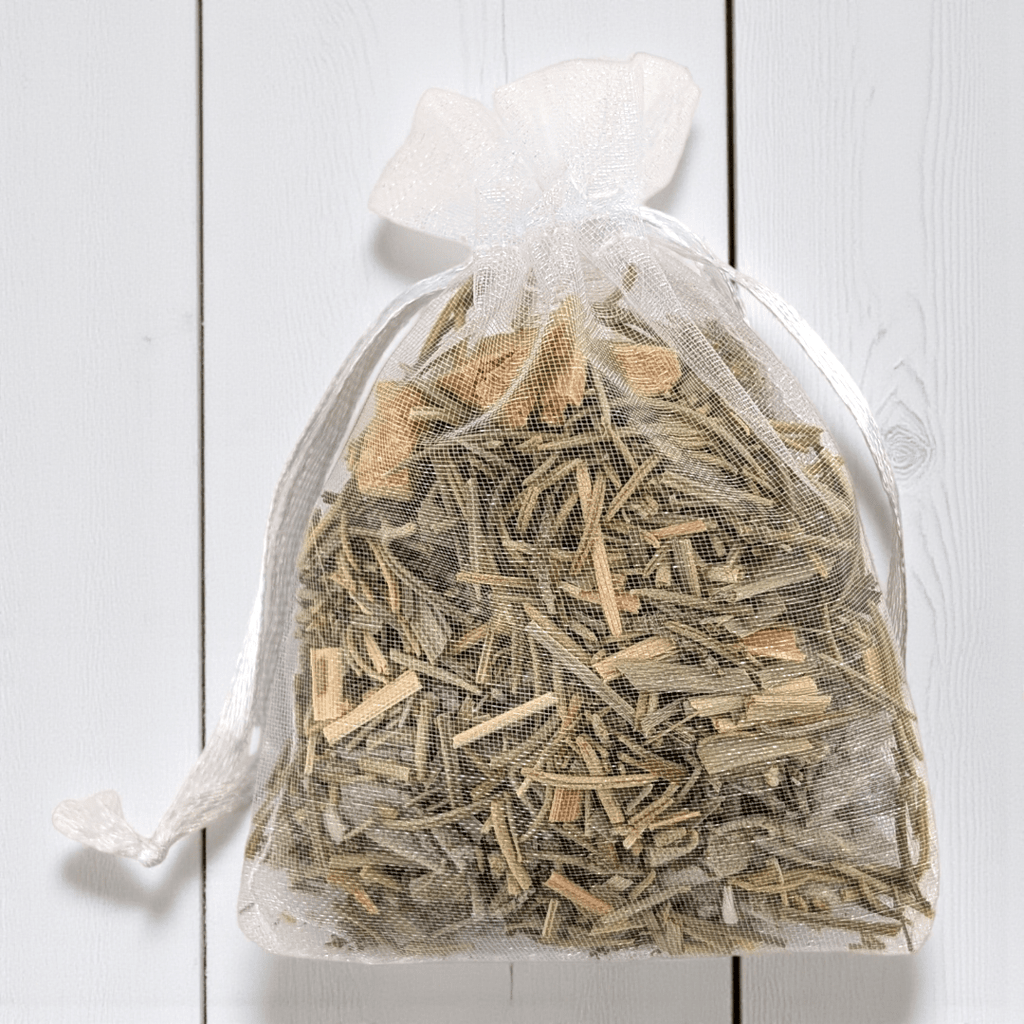 Two transparent bags filled with dried witch herbs on a light wooden surface. Available at Zen Collection Metaphysical Stores Barrie