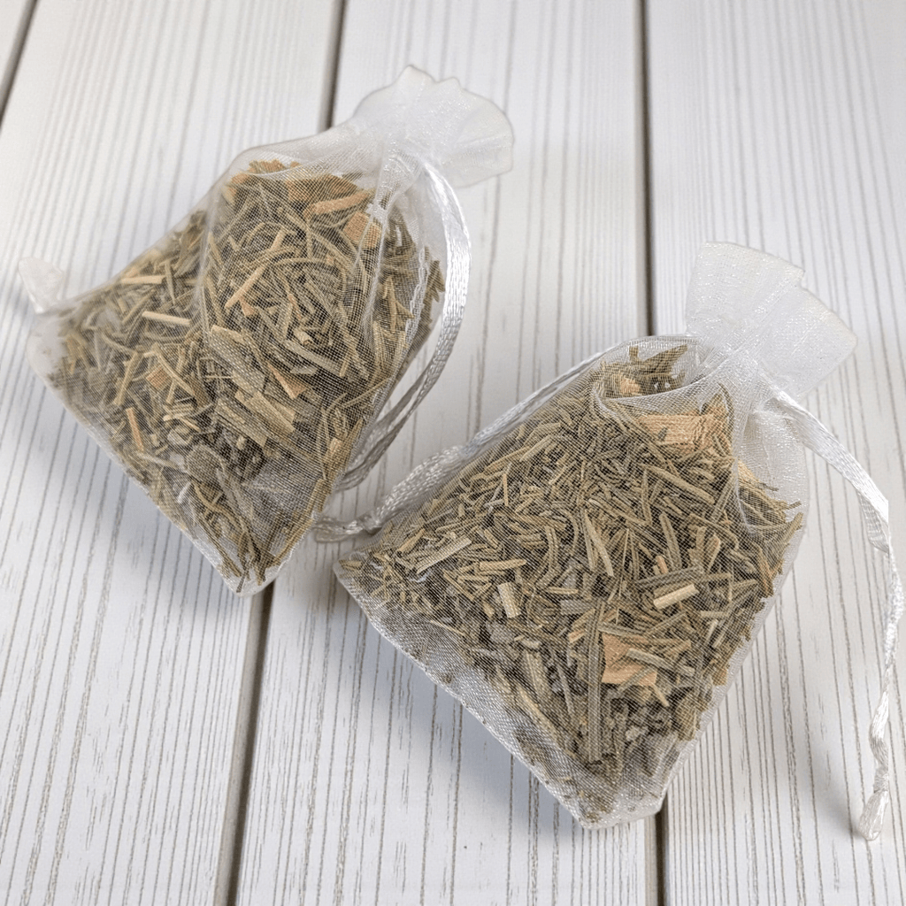 Two transparent bags filled with dried witch herbs on a light wooden surface. Available at Zen Collection Metaphysical Stores Barrie