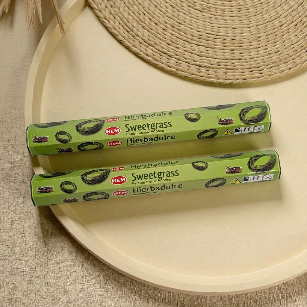 Two boxes of HEM Sweetgrass incense on a beige surface with a woven mat in the background. incense near me available at zen collection metaphysical stores Barrie