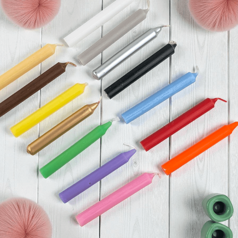 Colorful candles arranged on a white wooden surface. Spell Candle kit available at zen collection crystal store in Barrie.