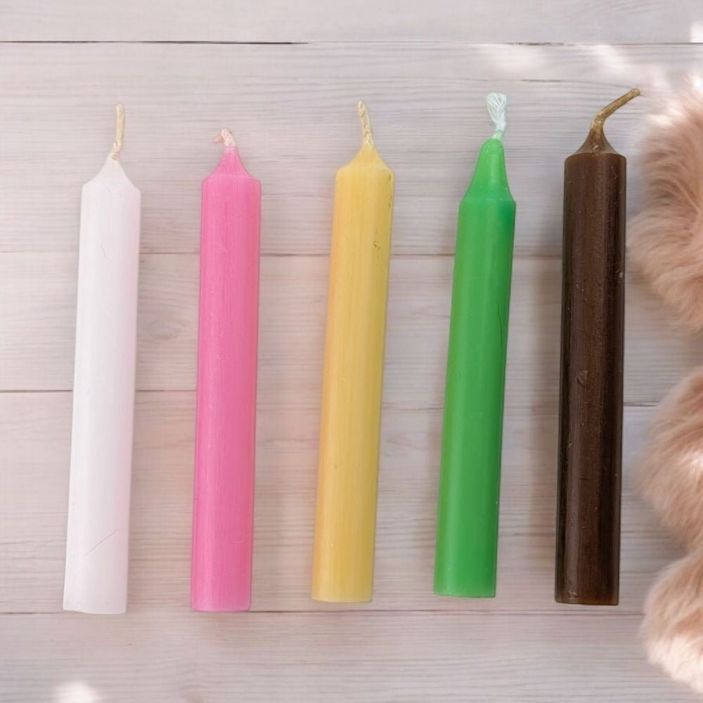 Five colorful ritual candles for steady success and humble leadership on a wooden surface