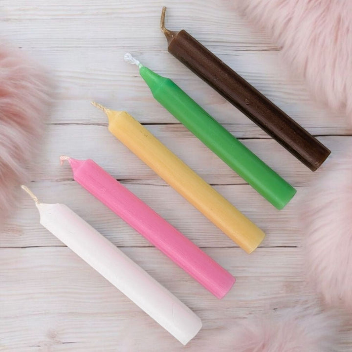Five colorful fertility blessing candle set with five chime candles on a wooden surface