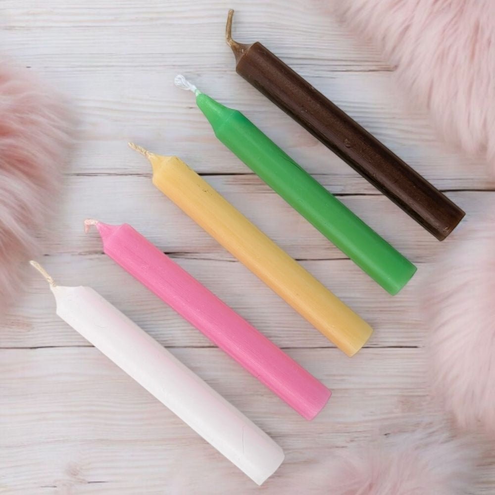 Five colorful fertility blessing candle set with five chime candles on a wooden surface
