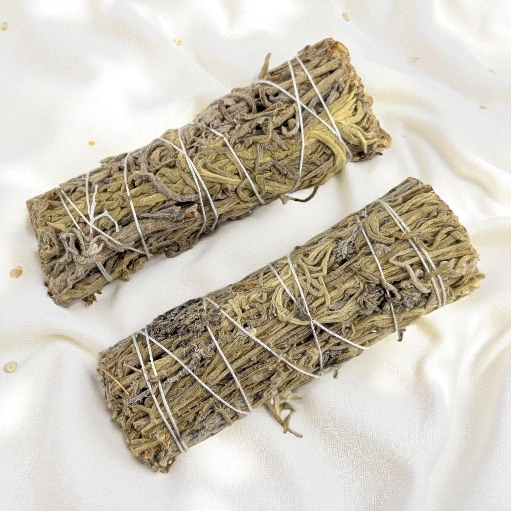 Two bundles of  green sage wrapped in twine on a white fabric background available today at zen collection crystal store