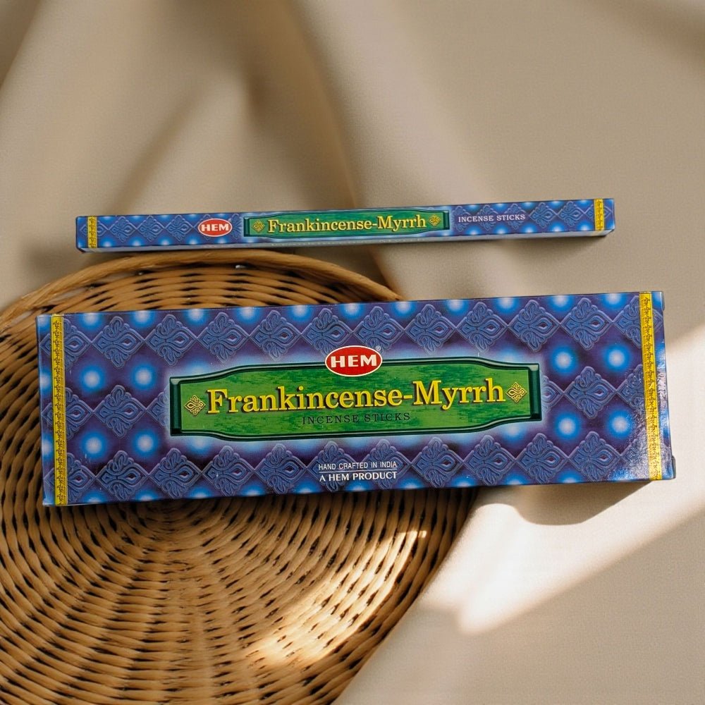 Two boxes of HEM Frankincense-Myrrh incense sticks on a woven surface. available at a metaphysical store near me