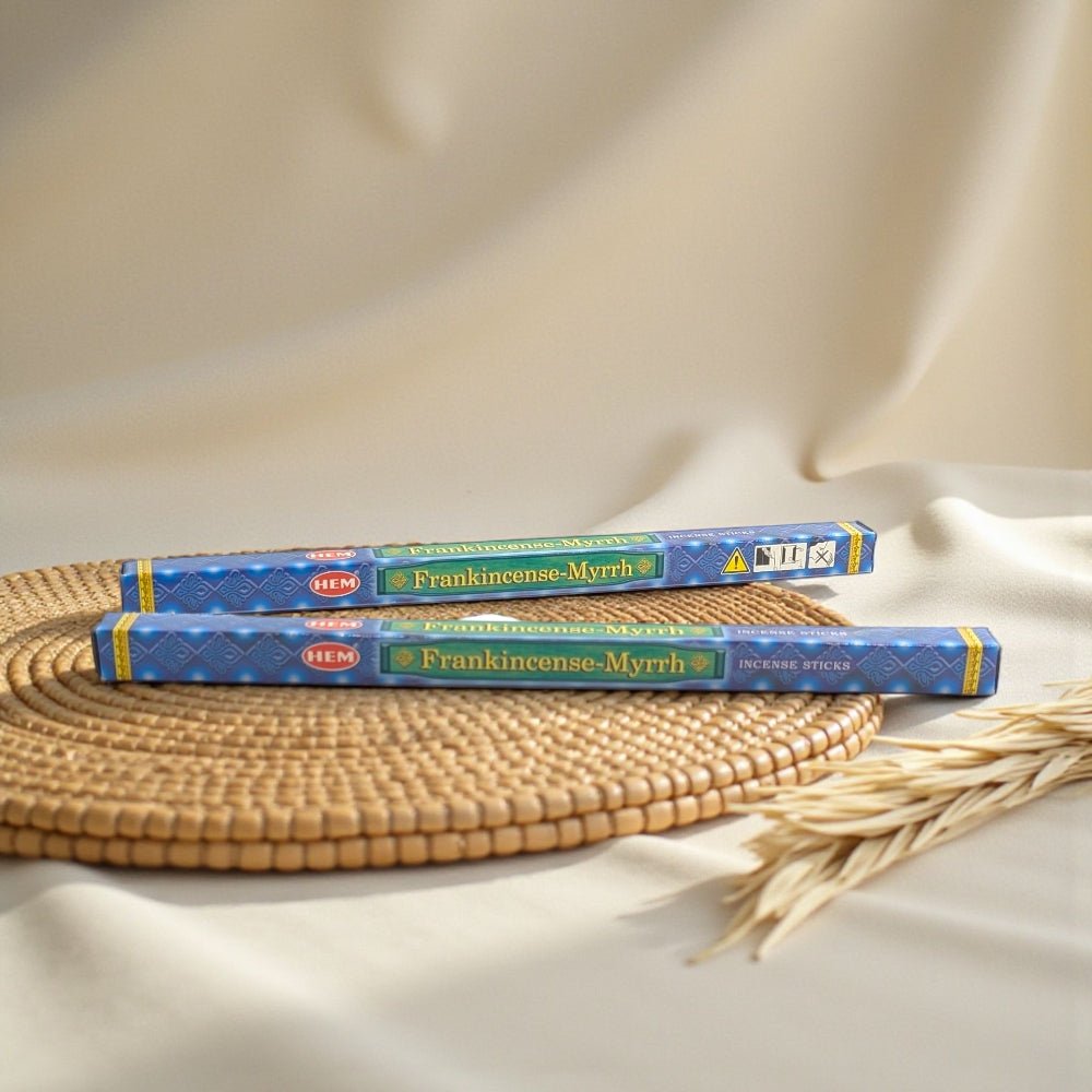 Two boxes of HEM Frankincense-Myrrh incense on a woven mat with wheat stalks. available at a crystal store near me