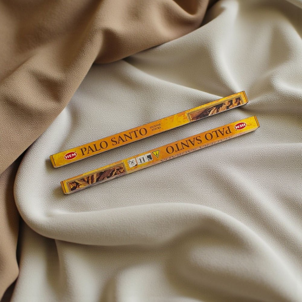 Two Palo Santo incense sticks in their packaging on beige fabric available at zen collection crystal store in barrie