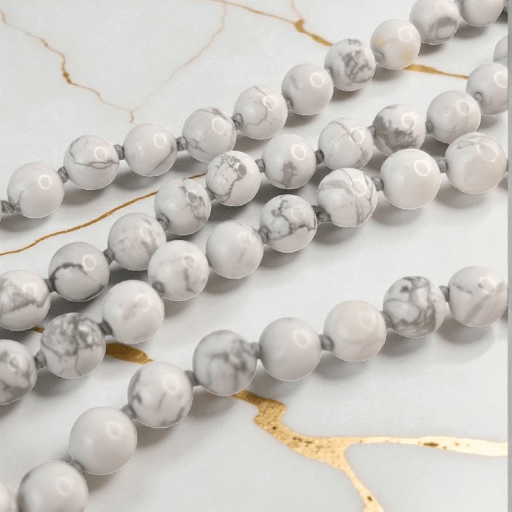 hand knotted howlite crystal mala with 108 beads on a white background. Available at at Zen Collection Metaphysical store