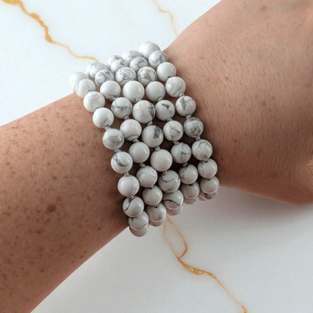 hand knotted howlite crystal mala with 108 beads on a white background. Available at at Zen Collection Metaphysical store