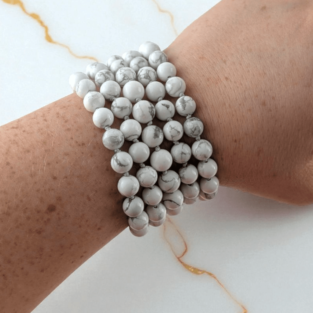 hand knotted howlite crystal mala with 108 beads on a white background. Available at at Zen Collection Metaphysical store