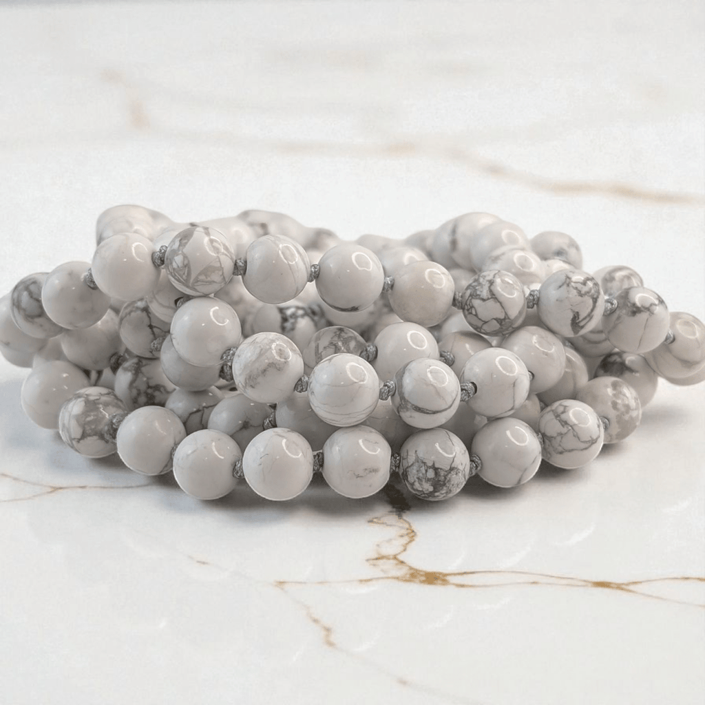 hand knotted howlite crystal mala with 108 beads on a white background. Available at at Zen Collection Metaphysical store