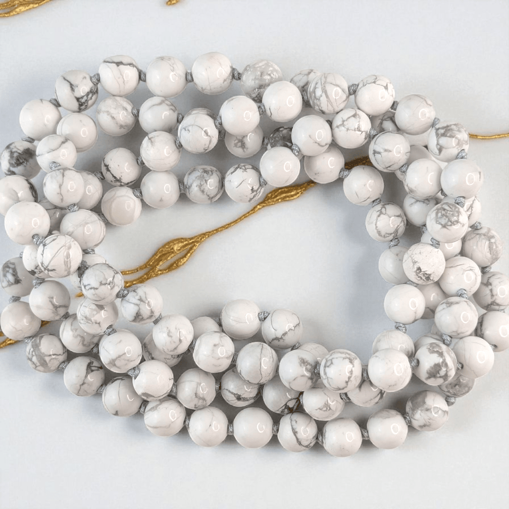 hand knotted howlite crystal mala with 108 beads on a white background. Available at at Zen Collection Metaphysical store
