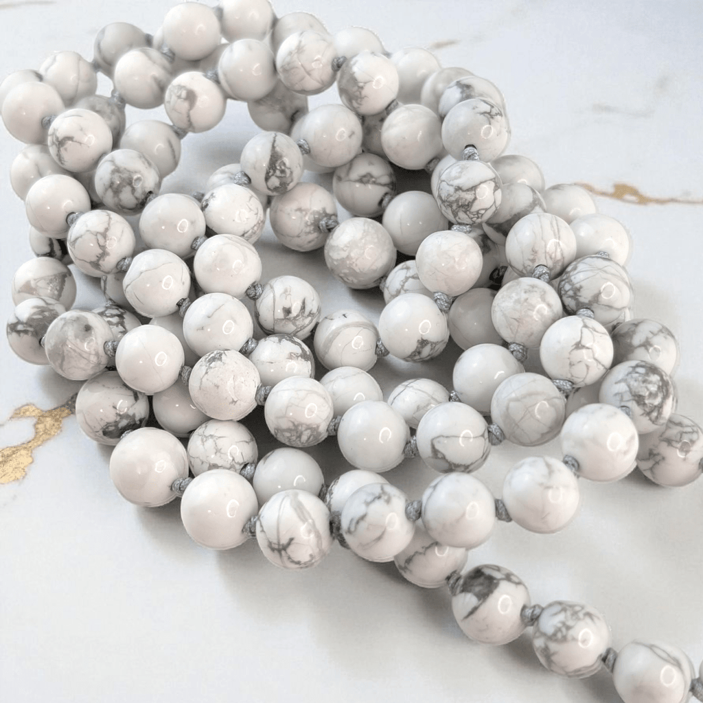 hand knotted howlite crystal mala with 108 beads on a white background. Available at at Zen Collection Metaphysical store