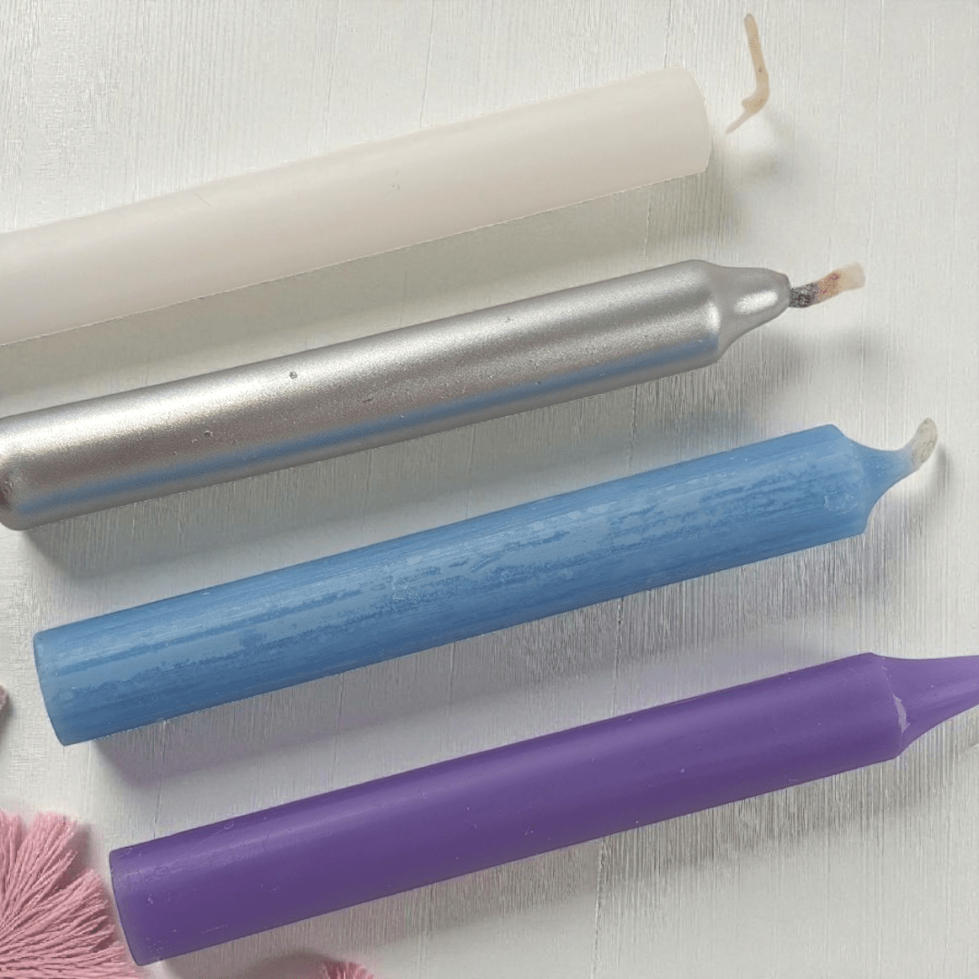 Three colored  spell candles with wicks on a white background shop in-store at our crystal shop in Barrie or online 24/7