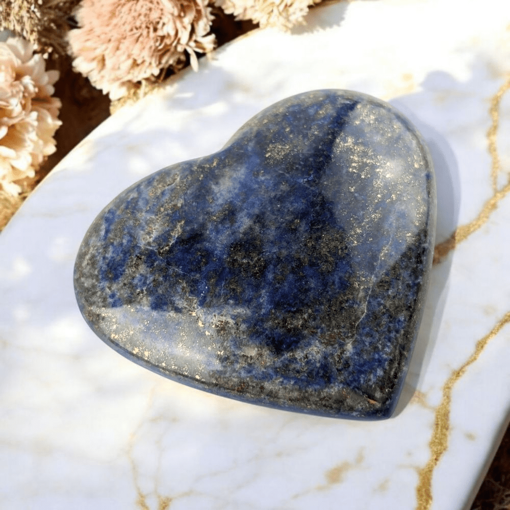 Lapis Lazuli crystal heart on neutral background